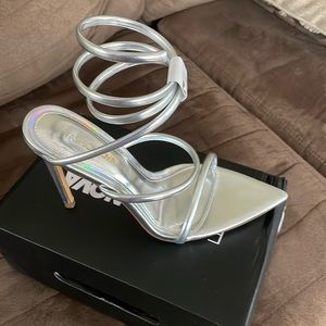 *BRAND NEW* Strappy heel. Wraps around ankle. Silver. NEW. Never worn. Size 8